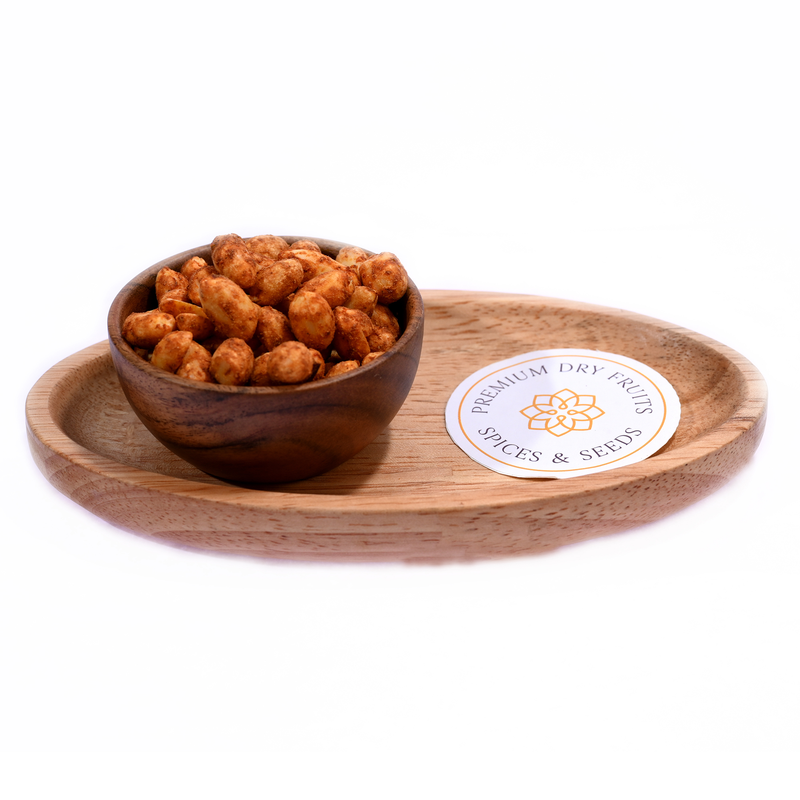 A close-up of vibrant chilli garlic peanuts arranged in a rustic bowl, showcasing their textured crunch and flavorful seasoning.