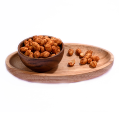 A handful of spicy chilli garlic peanuts with visible garlic bits, emphasizing their irresistible savory aroma.