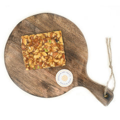 Dry fruit chikki is a popular Indian sweet made from a mix of nuts (such as almonds, cashews, and pistachios) and jaggery